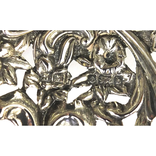 683 - Silver twin handled bon bon dish profusely embossed with flowers and vines and pierced decoration, H... 