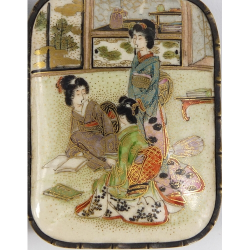 431 - Japanese Satsuma pottery two piece buckle, hand painted with robed ladies in an interior, 9cm wide