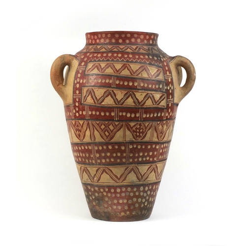 522 - Large Middle Eastern terracotta four handled vessel, finger painted with geometric motifs, 59cm high