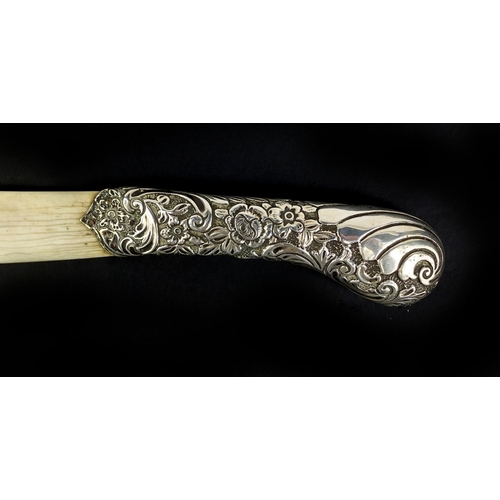 674 - Victorian silver and ivory page turner in the form of a scimitar, the handle profusely embossed with... 