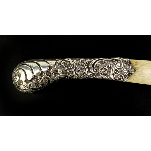 674 - Victorian silver and ivory page turner in the form of a scimitar, the handle profusely embossed with... 