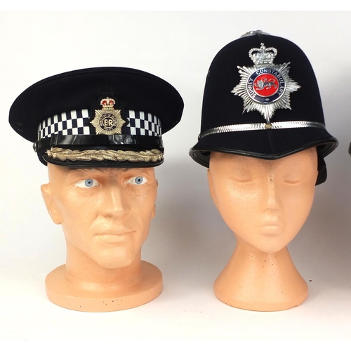 335 - Two vintage Ministry of Defence Police Peak caps together with two vintage police Rose top helmets c... 