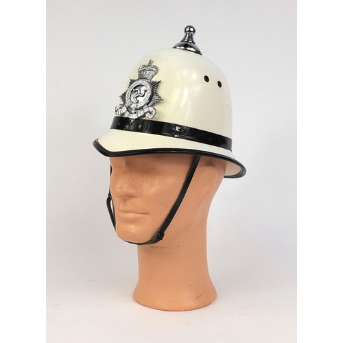 315 - Vintage Isles of Man police Ball top helmet, with Queens star badge and chin strap, size 54, 23cm hi... 