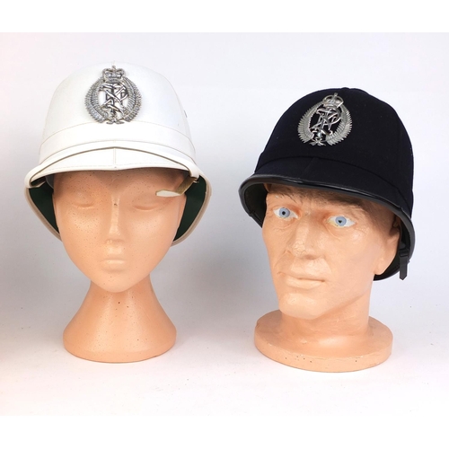 341 - Three vintage New Zealand six panelled police helmets, with badges, the largest 19cm high