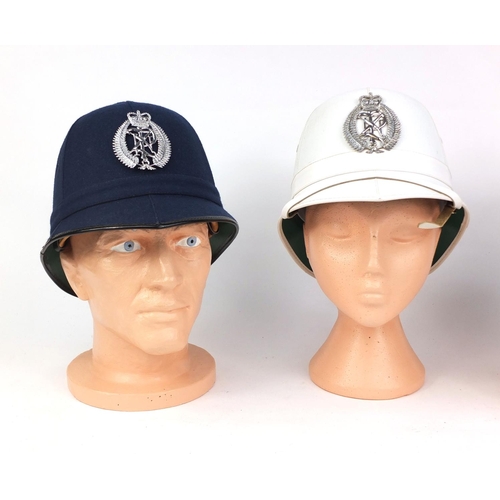 341 - Three vintage New Zealand six panelled police helmets, with badges, the largest 19cm high