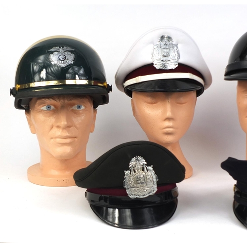 350 - Group of six police helmets/peak caps including a Sheriffs motorcycle hard hat and a Marshals motorc... 