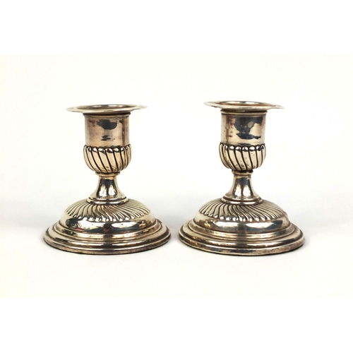 685 - Pair of Victorian silver dwarf candlesticks with demi fluted decoration, E.F.H.T London 1890, 9cm hi... 