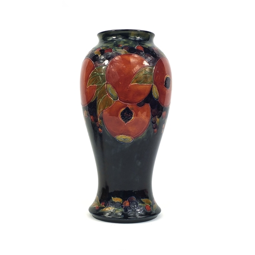 618 - Large William Moorcroft pomegranate pattern pottery vase of baluster form, with hand painted and tub... 