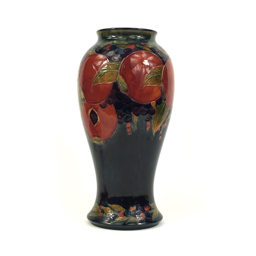 618 - Large William Moorcroft pomegranate pattern pottery vase of baluster form, with hand painted and tub... 