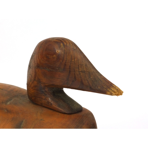 112 - Two carved wooden duck decoys, one impressed Victor to the base, the largest 40cm long