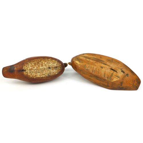 112 - Two carved wooden duck decoys, one impressed Victor to the base, the largest 40cm long