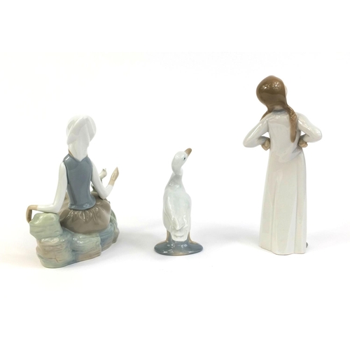 2082 - Three Lladro figures comprising one of a lady with a dove, girl in nightie and a goose, the largest ... 