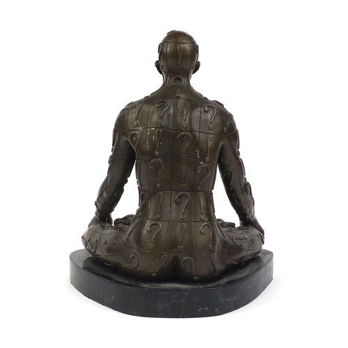 2205 - Bronzed figure of a mystery man seated in the lotus position raised on a faux marble base, 30cm high