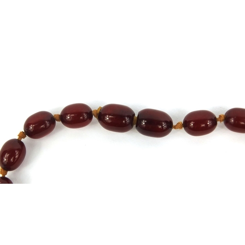 851 - Cherry amber coloured bead necklace, 42cm long, approximate weight 19.0g