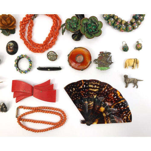 843 - Assorted jewellery including a Scottish hard stone brooch, coral necklace, hand painted glass bead n... 