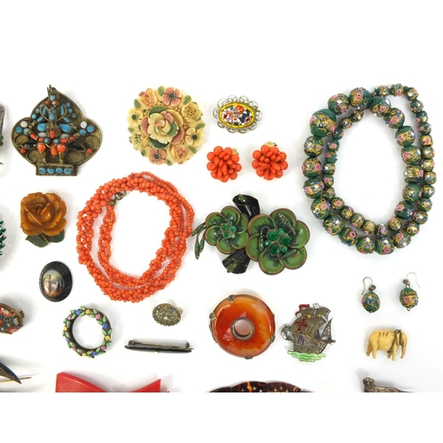 843 - Assorted jewellery including a Scottish hard stone brooch, coral necklace, hand painted glass bead n... 