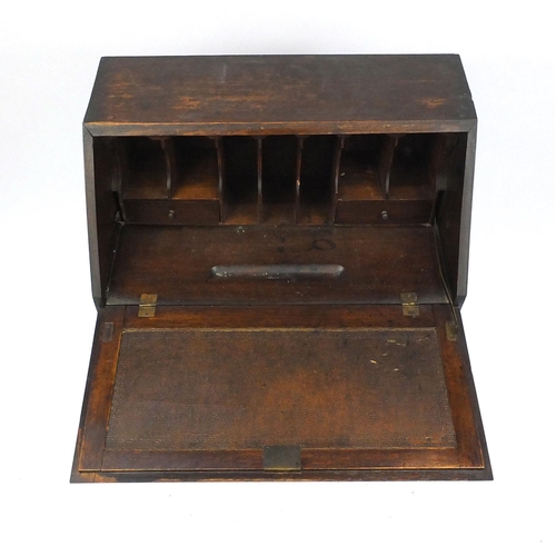 71 - Carved oak bureau fitted with a fall above two drawers, 101cm high x 73cm wide x 43cm deep