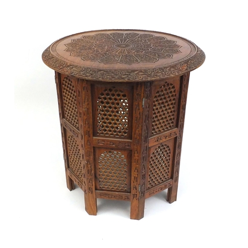 17 - Middle Eastern carved wooden folding occasional table, 50cm high x 45cm in diameter