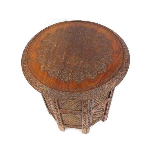 17 - Middle Eastern carved wooden folding occasional table, 50cm high x 45cm in diameter