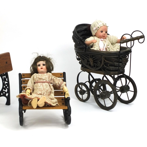 2353 - Group of three dolls together with group of dolls accessories including a pram and bench, the dolls ... 