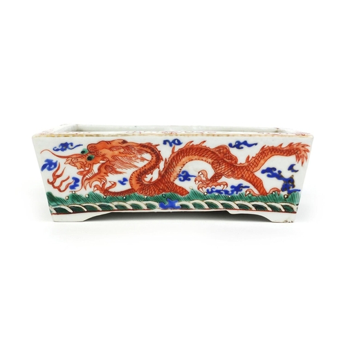 359 - Chinese rectangular porcelain planter, hand painted with dragons chasing the flaming pearl, six figu... 