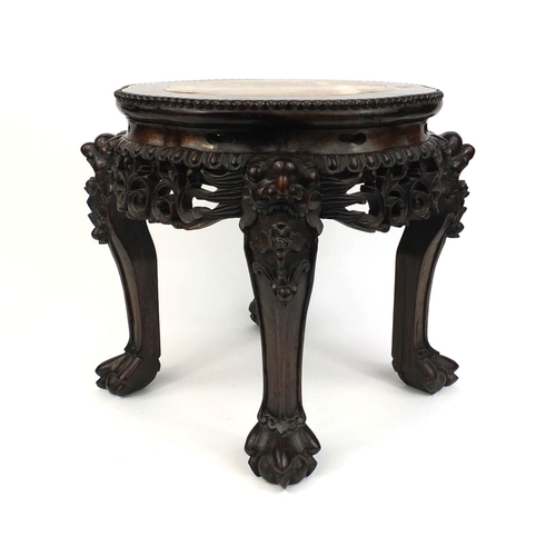 473 - Chinese hardwood stand with marble inset top, above a pierced frieze, the legs carved with mythical ... 