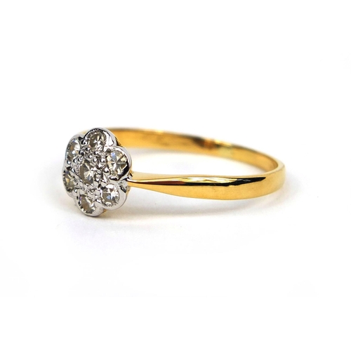 822 - 18ct gold diamond flower head ring set with seven diamonds, size T, approximate weight 2.2g