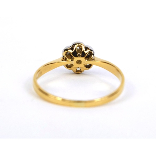 822 - 18ct gold diamond flower head ring set with seven diamonds, size T, approximate weight 2.2g