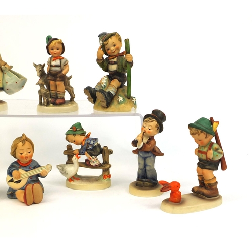 2096 - Group of nine Goebel Hummel figures including a boy with a trumpet and a boy with a duck, the larges... 