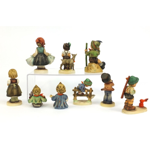 2096 - Group of nine Goebel Hummel figures including a boy with a trumpet and a boy with a duck, the larges... 