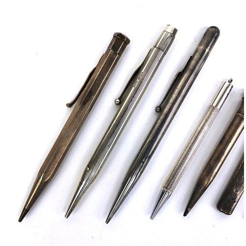 77 - Group of mostly silver propelling pencils and a silver pencil holder, the propelling pencils includi... 