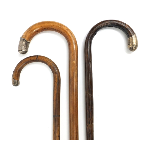 2367 - Group of three silver mounted walking canes including two bamboo examples, the largest 93cm long