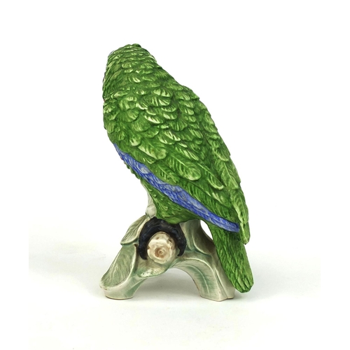 2095 - Goebel hand painted parrot perched on a branch, factory marks and No.1967 to the base, 22cm high