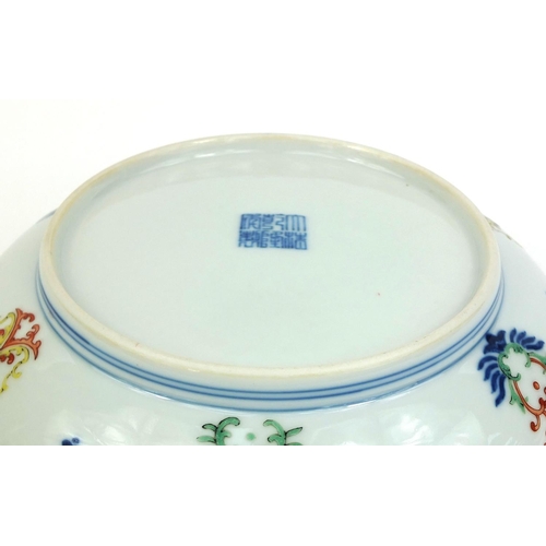363 - Chinese porcelain shallow dish, hand painted in the Wucai palette with foliate scroll within blue ri... 