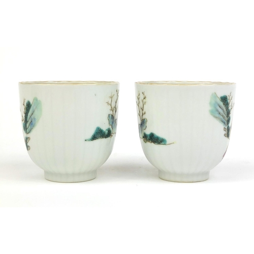 364 - Pair of Chinese porcelain tea cups painted in the famille rose palette with court figures playing, f... 
