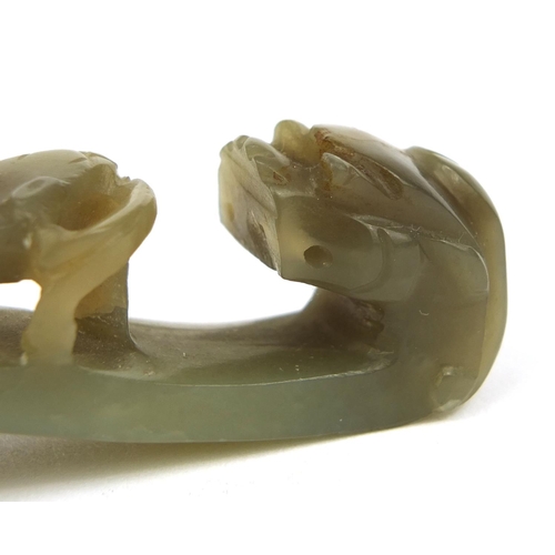 438 - Chinese green jade belt hook carved with a dragon, 8cm in length