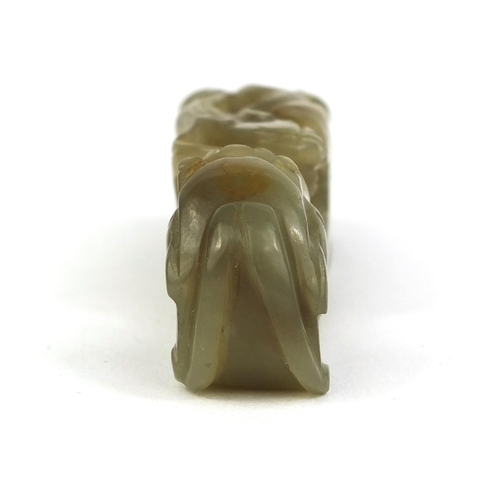 438 - Chinese green jade belt hook carved with a dragon, 8cm in length