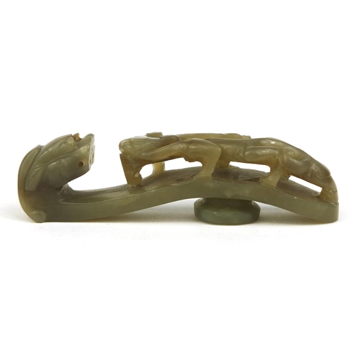 438 - Chinese green jade belt hook carved with a dragon, 8cm in length