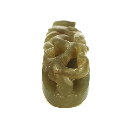 438 - Chinese green jade belt hook carved with a dragon, 8cm in length