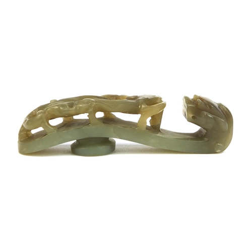 438 - Chinese green jade belt hook carved with a dragon, 8cm in length