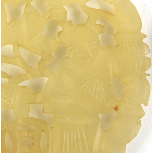 440 - Chinese circular jade pendant carved with two figures together with one other, the largest 6cm high