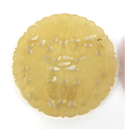 440 - Chinese circular jade pendant carved with two figures together with one other, the largest 6cm high