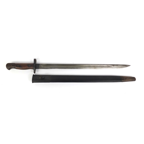 306 - Military interest World War I Wilkinson 1907 pattern bayonet, with wooden grip and leather scabbard,... 