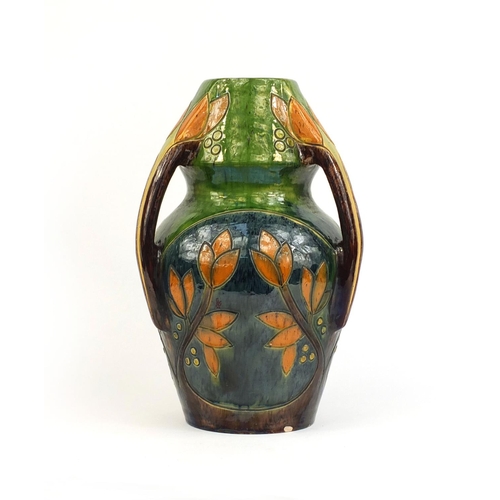 615 - Art Nouveau three handled pottery vase, incised and hand painted with stylised flowers, 44cm high