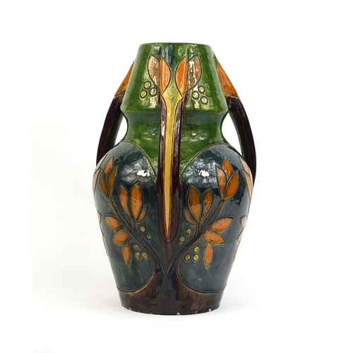 615 - Art Nouveau three handled pottery vase, incised and hand painted with stylised flowers, 44cm high