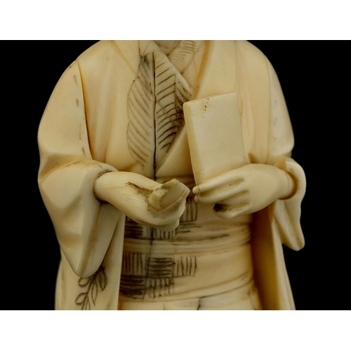 461 - Japanese carved ivory okimono of a girl holding a comb, red inset character marks to the base, 17cm ... 