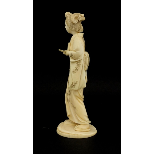 461 - Japanese carved ivory okimono of a girl holding a comb, red inset character marks to the base, 17cm ... 