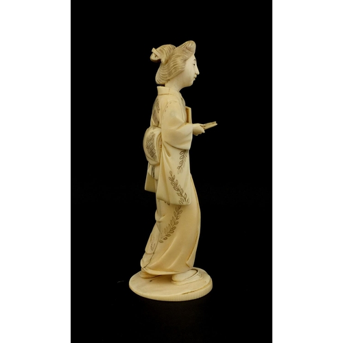 461 - Japanese carved ivory okimono of a girl holding a comb, red inset character marks to the base, 17cm ... 