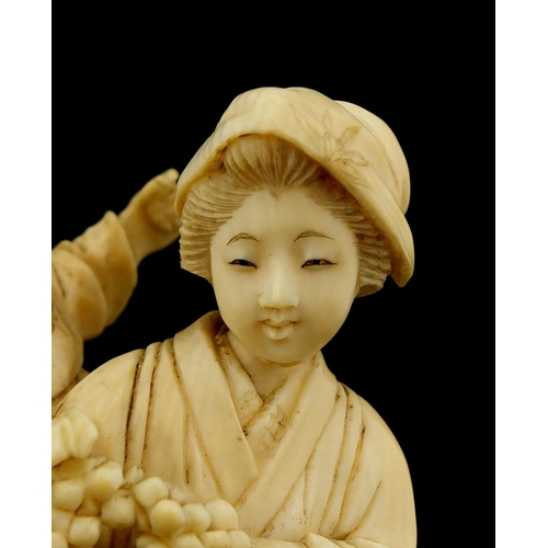 457 - Japanese carved ivory okimono of a mother holding her baby and grapes, character marks to the base, ... 