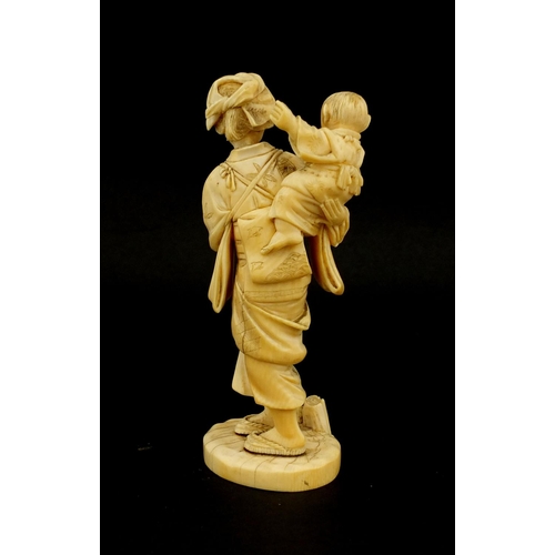 457 - Japanese carved ivory okimono of a mother holding her baby and grapes, character marks to the base, ... 